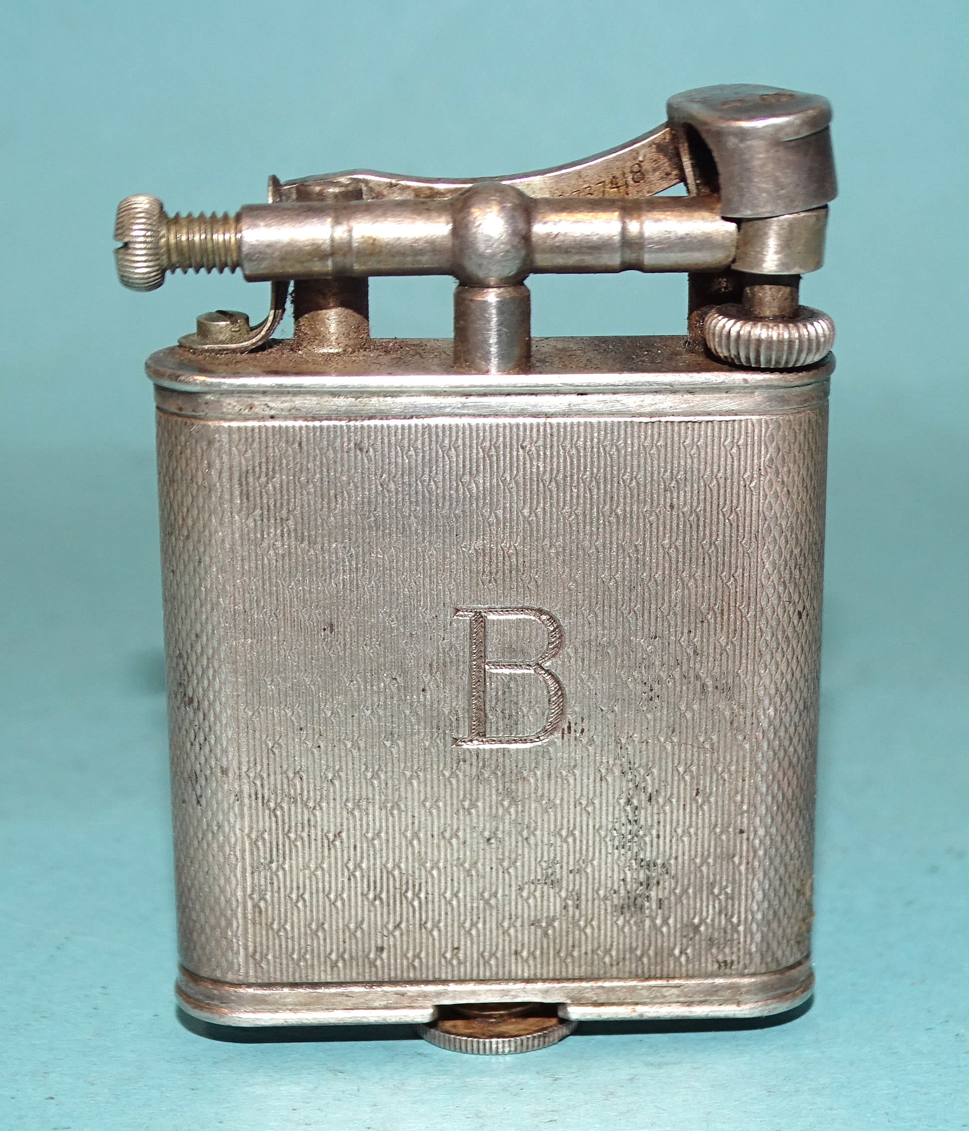 A hallmarked silver Dunhill lighter with engine-turned body, London 1928, Pat. no.390107, (a/f, fuel