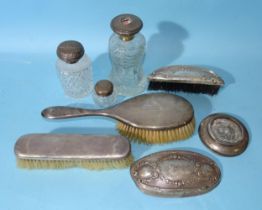 A late-Victorian hobnail-cut glass scent bottle with embossed silver twist lid, decorated with a