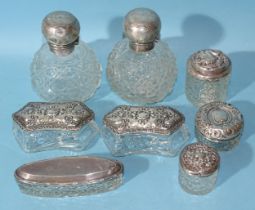 A pair of Edwardian cut-glass scent bottles with silver hinged lids, 11.5cm high, Birmingham