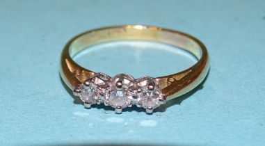 A three-stone diamond ring claw-set brilliant-cut diamonds, in 18ct yellow gold and platinum