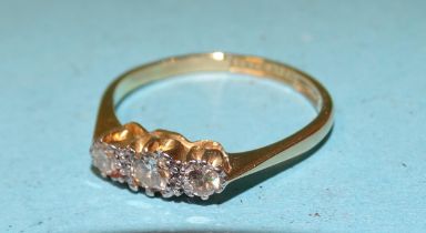 A three-stone diamond ring claw-set brilliant-cut diamonds, in 18ct gold and platinum mount, size P,
