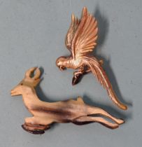 A painted horn brooch in the form of a parrot, 73mm and a horn brooch in the form of a leaping