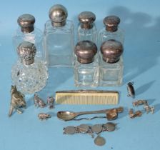 A late Victorian glass scent bottle with embossed silver screw cover, 9cm high, four other silver-