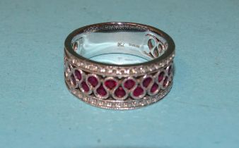 An 18ct white gold ring set fifteen round-cut rubies between two lines of a total of thirty-four