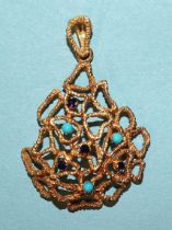 A 9ct yellow gold pendant of abstract design set small turquoise and sapphire stones, 5cm long (with