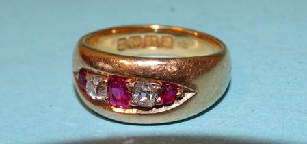 An 18ct gold gipsy ring set three rubies and two old-cut diamonds, size L, 7.6g.
