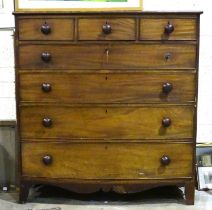 A large Georgian mahogany bow-front chest of three short and four long cockbeaded drawers, on