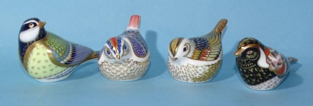 A collection of four Royal Crown Derby bird paperweights: "Great Tit", "Firecrest", "Bunting" and "