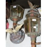 A pair of brass external lanterns, each surmounted by an eagle, (in need of restoration), (2).