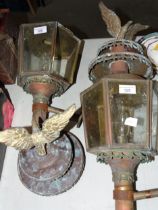 A pair of brass external lanterns, each surmounted by an eagle, (in need of restoration), (2).