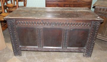 An antique carved oak panelled coffer, 123cm long, 54cm deep, 65cm high.