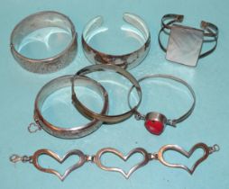 Two silver hinged bangles, a beaten 925-silver bangle and four other silver bracelets, (two set