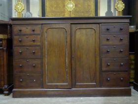 A late-George-III mahogany low press cupboard, the cornice above a pair of panelled doors