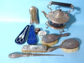 Two silver-backed hair brushes, a silver-plated spirit kettle, plated grape scissors, a silver-