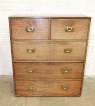 A 19th century teak military chest in two parts, fitted with two short and three long drawers,