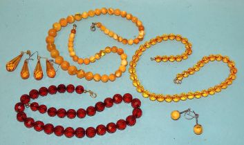 Three modern amber necklaces and three pairs of drop earrings, gross weight 94g.