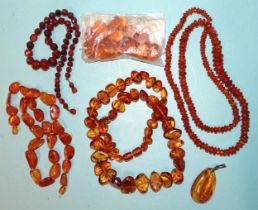 A necklace of graduated amber chips, two late-20th century amber necklaces, a pendant, a short