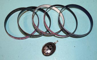 A "Michaela Frey Team" enamelled bangle, four others, similar and a Michaela Frey locket.