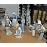 Collection of Lladro figures, to comprise seven female figures holding animals, flowers and herding