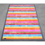 Cream Designs Ltd, London, a multicoloured dyed hide carpet, with leather seams,