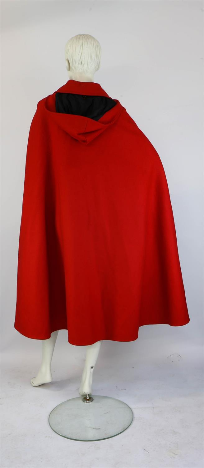 A 1970s original heavy cherry red wool long-length cape with hood, black buttons and arm slits. - Image 2 of 3