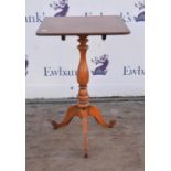 A mahogany tilt top occasional table of square top raised on single pedestal raised on tripod