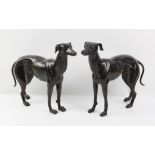 Pair of bronzed metal figures of a male and female greyhound, each approx. 29cm high x 38cm long