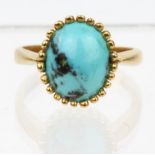 A single stone turquoise ring, in yellow metal stamped 18ct, ring size M