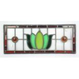 A stained glass panel with Tulip design to centre. 68 cm wide x27.5 cm high,together with a glass