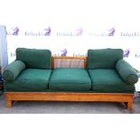 Walnut framed bergere settee, with cane panel back and arms, on later solid seat,