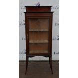 An Edwardian Mahogany and inlaid display cabinet with gallery above single glazed door raised on