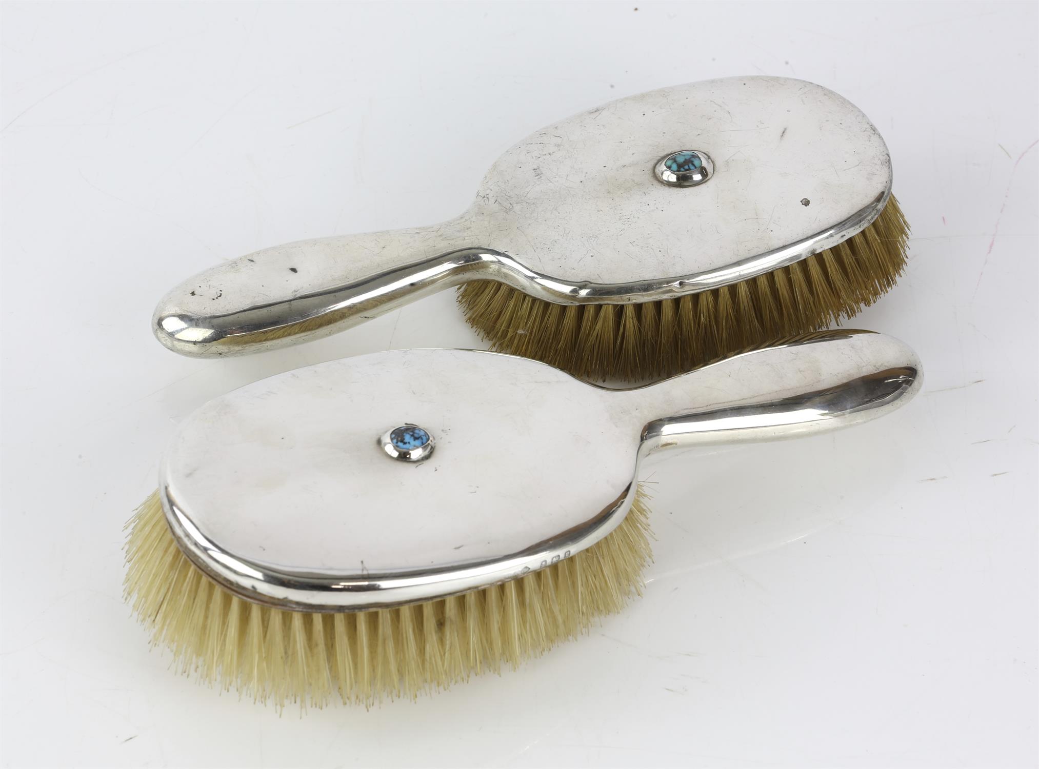 Pair of Liberty and Co turquoise inset silver hair brushes, Birmingham, 1906, 1910,