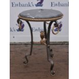 A circular marble topped Garadon table with rope twist decoration raised on tripod supports.