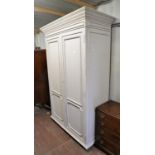 Cream painted wardrobe, with two panelled doors, on bracket feet, 208cm high x 127cm wide x 60cm