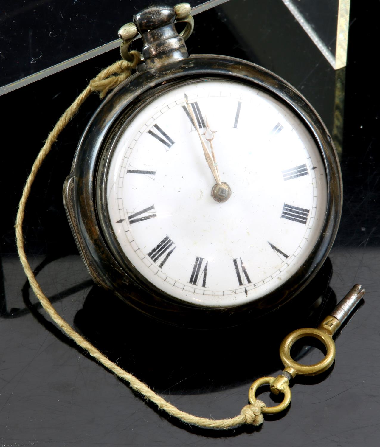 A silver pair case pocket watch, the white enamel dial with Roman numeral hour markers and