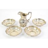 Four silver pierced bonbon dishes, marks for Walker and Hall, dates and assay office marks rubbed,