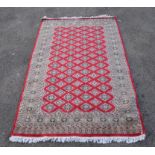 Three rugs, one with three rows of hooked motifs on a blue ground, 136 x 94cm, one with rows of