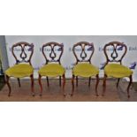 Four Victorian walnut dining chairs, open scrollwork splats, overstuffed seats, cabriole legs,