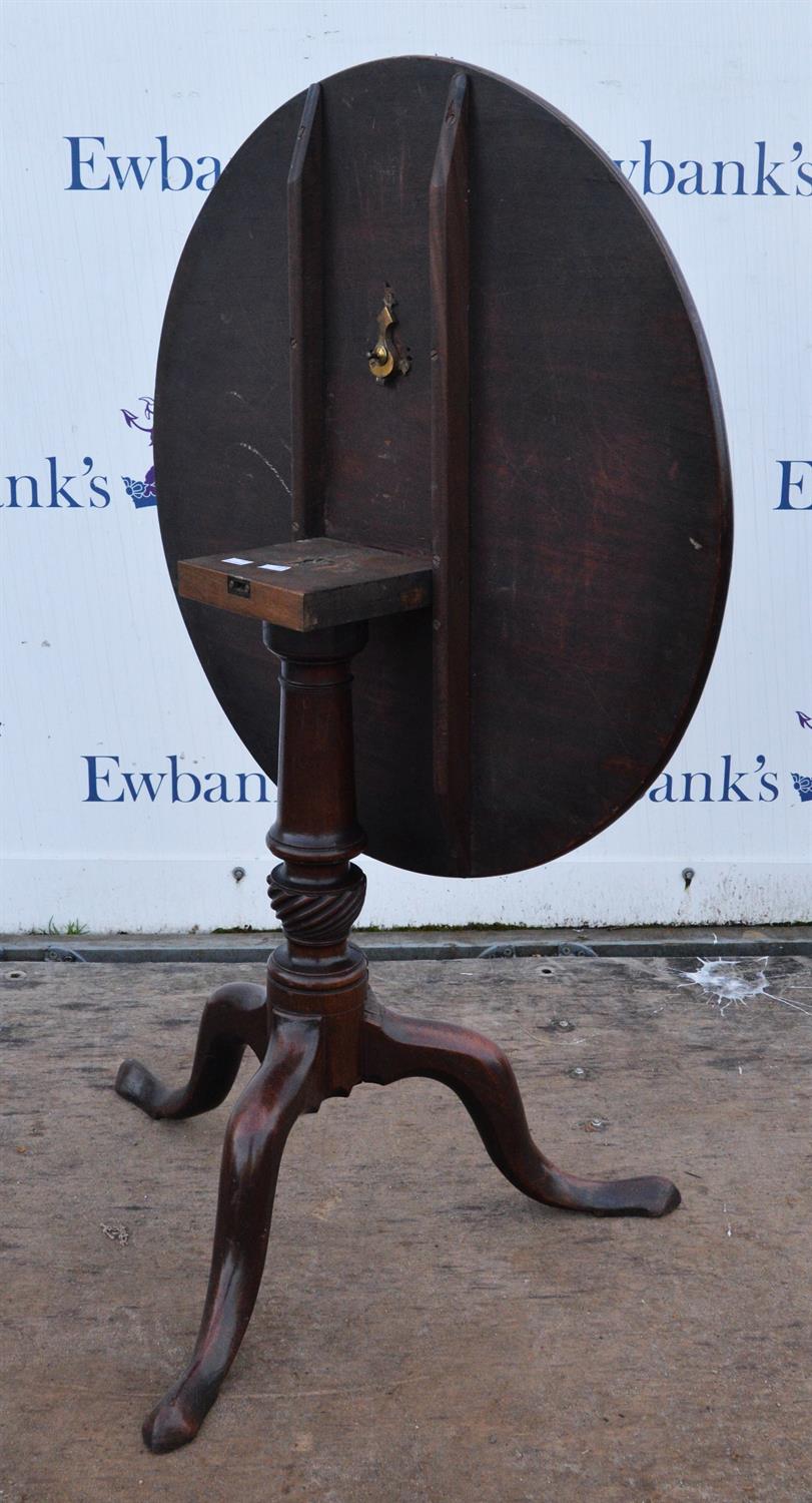 Circular mahogany tilt top table, 19th Century, on baluster stem, with tripod feet, 72cm high x 76. - Image 2 of 2