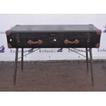 A leather trunk raised on metal base 125cm wide x 45cm deep x 84cm high.