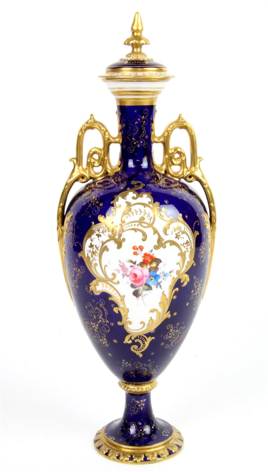 Royal Crown Derby vase and cover, the blue ground with reserve panels of flowers one signed C.