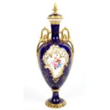 Royal Crown Derby vase and cover, the blue ground with reserve panels of flowers one signed C.