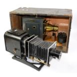 A Maltese Cross Empire lantern in a wooden case, together with a collection of slides of English