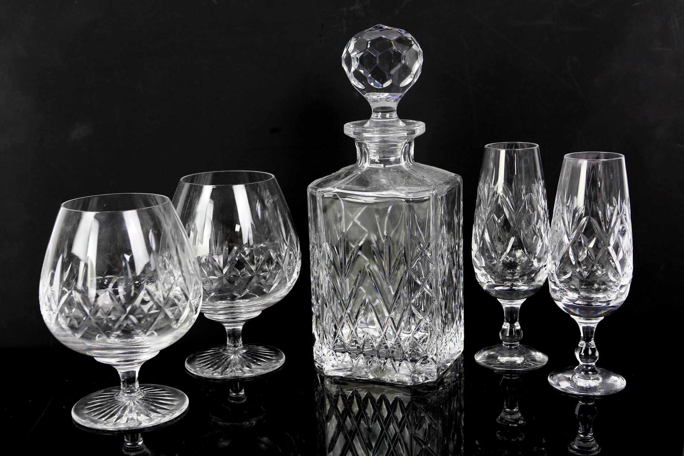 A large quantity of glassware including decanters, table lamp, shot glasses, tumblers,