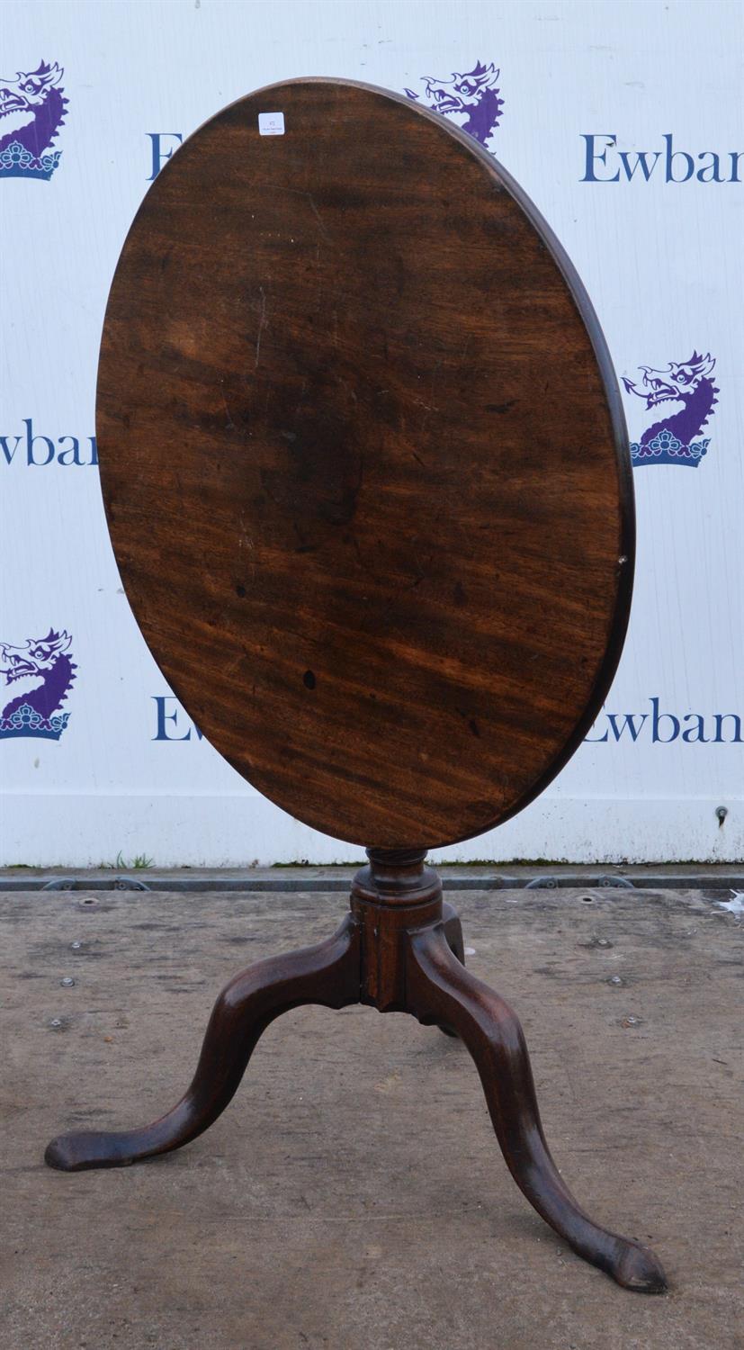 Circular mahogany tilt top table, 19th Century, on baluster stem, with tripod feet, 72cm high x 76.