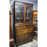 George III style mahogany secretaire bookcase, the dentil cornice over an astragal glazed pair of