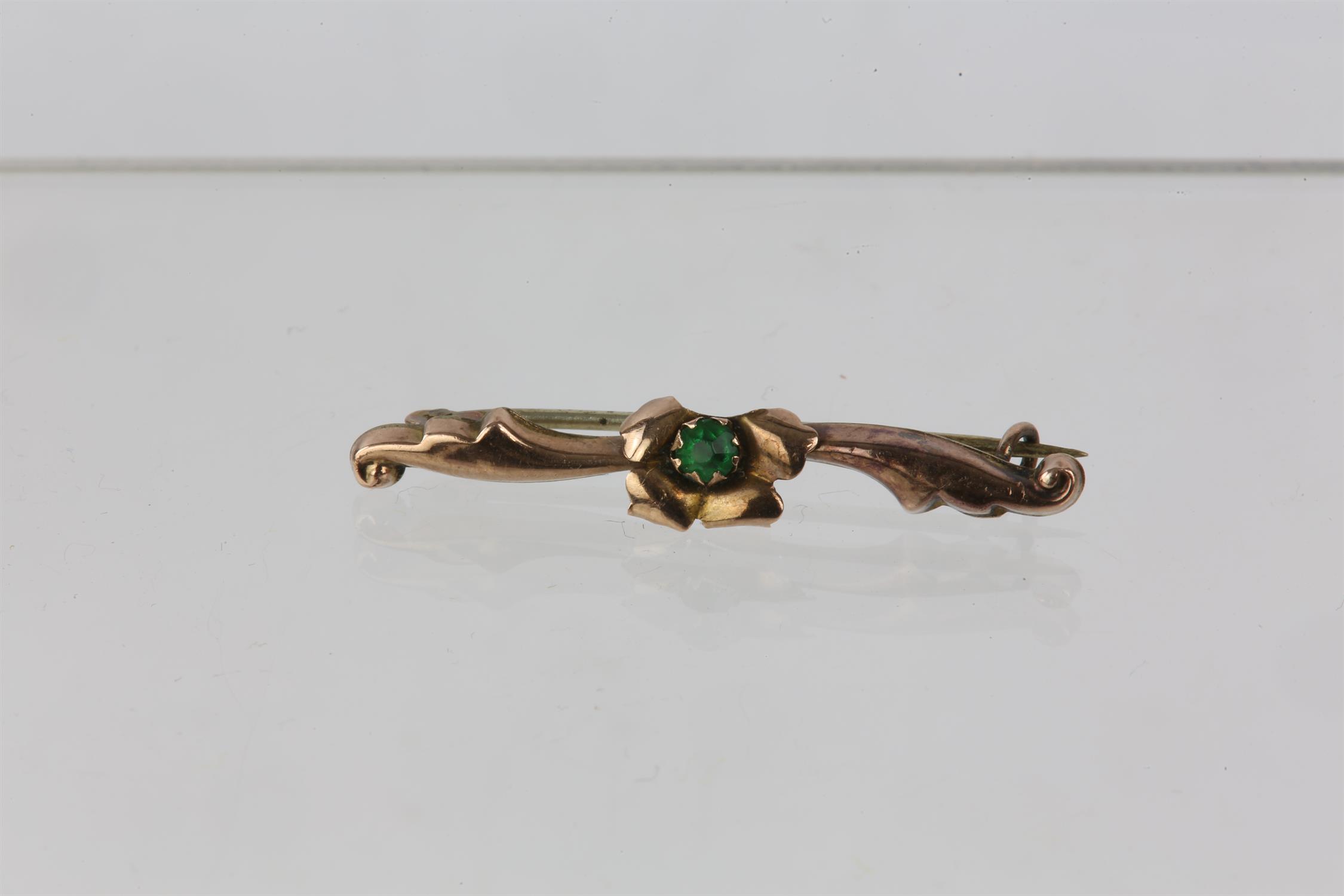 Floral bar brooch set with a green paste stone, set in yellow meta; with a partial 9ct stamp, - Image 3 of 3