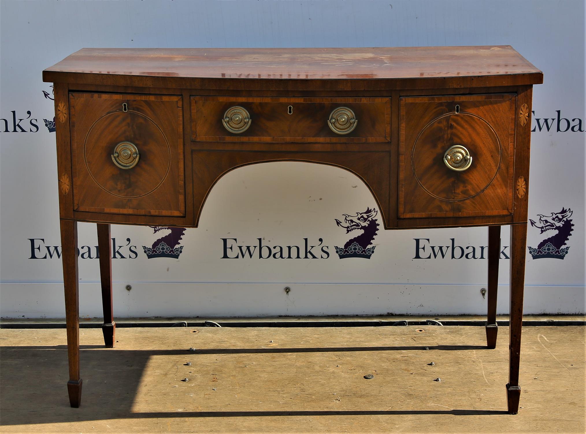 19th century mahogany bow fronted sideboard with single drawer flanked by two deep drawers on