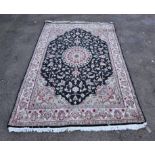 Afgan rug, with central petal medallion, on black gound with red, pistachio flowers on cream border,