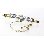 Three stone paste brooch, with three blue paste stones, tested as 9ct. with safety chain,
